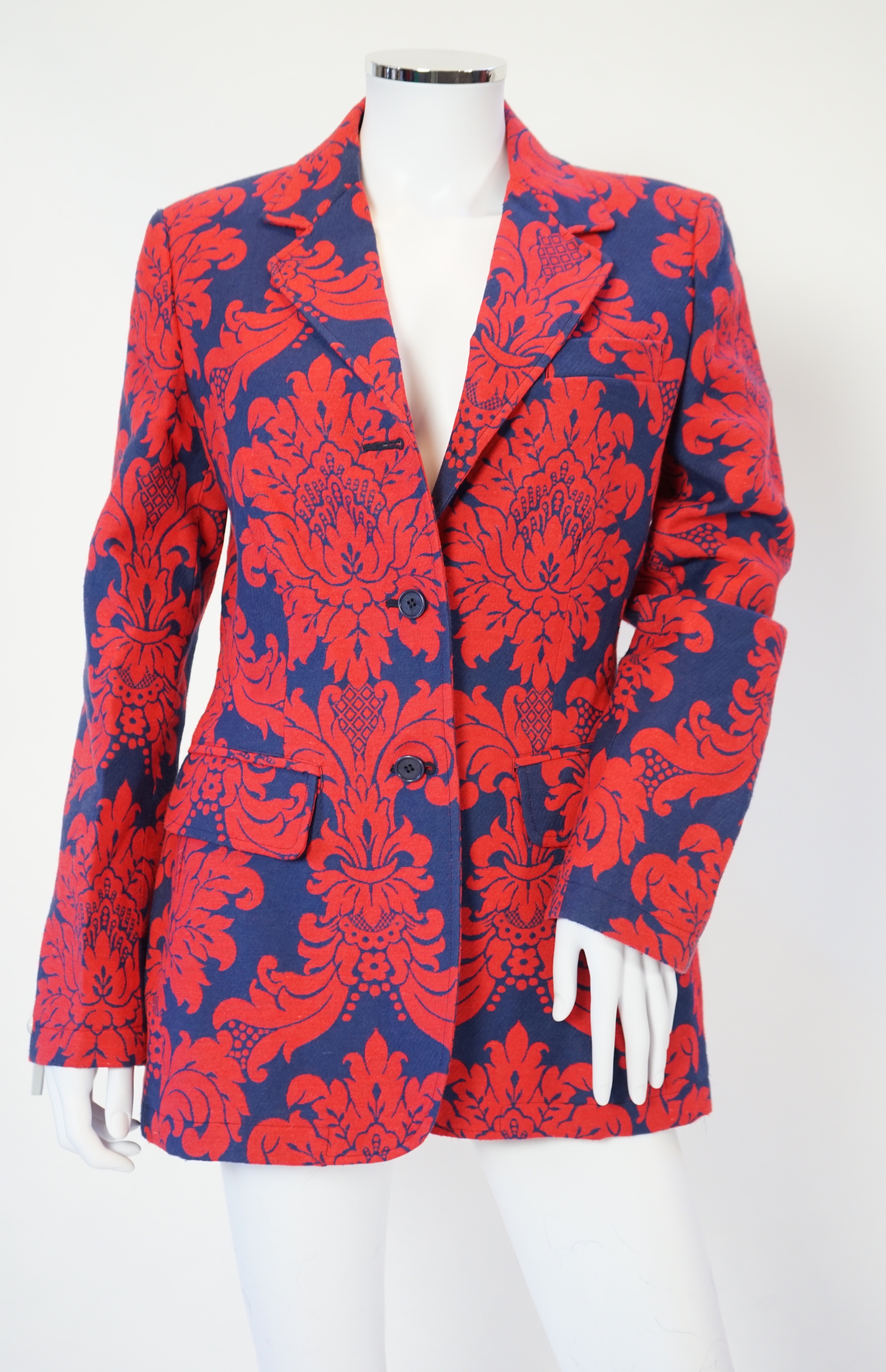 A Moschino lady's long blue and red jacket, a cream cotton embellished blazer and a cotton pair of floral trousers, blue and red jacket size 14, cream blazer size 12, trousers size: 10